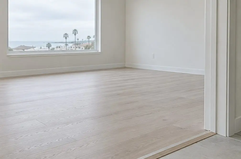 Illustration: the same room finished with pale engineered planks and a door threshold